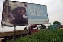 A photo shows a campaign signboad displayed by the ruling All Progressives Congress to show its readiness to defeat Boko Haram Islamists on July 3, 2015