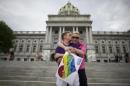 A couple embraces on the Pennsylvania State Capital steps following a rally with gay rights supporters in Harrisburg