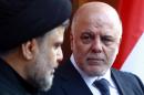 Iraqi Prime Minister Haider al-Abadi, pictured at right with radical Shiite cleric Moqtada al-Sadr in Najaf on November 7, 2015, warned Turkey December 7 that "only 24 hours remain" for Ankara's troops to leave a base near Mosul