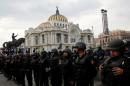 Riot police stand guard outside the Bellas Artes museum as protesters from the (CNTE) teachers' union take part a march against President Enrique Pena Nieto's education reform, in Mexico City