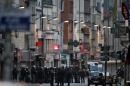 Police officers gather in the northern Paris suburb of Saint-Denis city centre on November 18, 2015, as French Police special forces raid an apartment, hunting those behind the attacks that claimed 130 lives