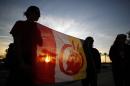 People holding the American Indian movement flag protest against the Keystone XL Pipeline, in Arcadia, California