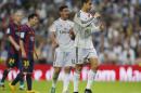 Real Madrid's Cristiano Ronaldo, right, gestures next to Barcelona's Lionel Messi, second left, during a Spanish La Liga soccer match between Real Madrid and FC Barcelona at the Santiago Bernabeu stadium in Madrid, Spain, Saturday, Oct. 25, 2014. (AP Photo/Andres Kudacki)