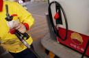 A gas station attendant pumps fuel into a customer's car at PetroChina's petrol station in Beijing