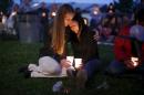 Heidi Wickersham comforts her sister Gwendoline during a candlelight vigil for victims of the Umpqua Community College shooting in Winston