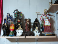 In this Feb. 12, 2013 photo, statues of La Sante Muerte from an altar run by Arely Vazquez Gonzalez, a Mexican immigrant and transgender woman, is shown inside a Queens, NY apartment. La Santa Muerte, an underworld saint most recently associated with the violent drug trade in Mexico, now is spreading throughout the U.S. among a new group of followers ranging from immigrant small business owners to artists and gay activists. (AP Photo/Russell Contreras)