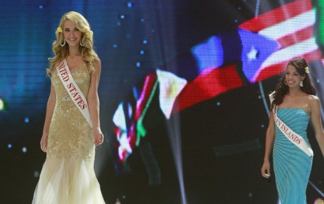 Miss United States Olivia Jordan and Miss US Virgin Island Petra Cabrera Badia walk on stage during opening of the 63rd Miss World Pageant ceremony in Nusa Dua, Bali, Indonesia on Sunday, Sept. 8, 2013. (AP Photo/Firdia Lisnawati)