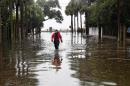 A firefighter walks on a flooded street in downtown Charleston, South Carolina on October 4, 2015