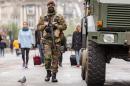 A Belgian Army soldier patrols on a main boulevard in Brussels, Sunday, Nov. 22, 2015. Western leaders stepped up the rhetoric against the Islamic State group on Sunday as residents of the Belgian capital awoke to largely empty streets and the city entered its second day under the highest threat level. With a menace of Paris-style attacks against Brussels and a missing suspect in the deadly Nov. 13 attacks in France last spotted crossing into Belgium, the city kept subways and underground trams closed for a second day. (AP Photo/Geert Vanden Wijngaert)