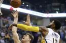 Indiana Pacers forward Paul George (13) blocks a shot attempt by Los Angeles Lakers center Timofey Mozgov during the first half of an NBA basketball game, Tuesday, Nov. 1, 2016, in Indianapolis. (AP Photo/R Brent Smith)