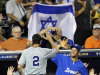 Israel's Josh Satin (2) is congratulated after scoring on a double by Charlie Cutler against South Africa in the eighth inning of a World Baseball Classic qualifier baseball game in Jupiter, Fla., Wednesday, Sept. 19, 2012. Shawn green and Jack Marder also scored on the double. Israel won 7-3. (AP Photo/Alan Diaz)