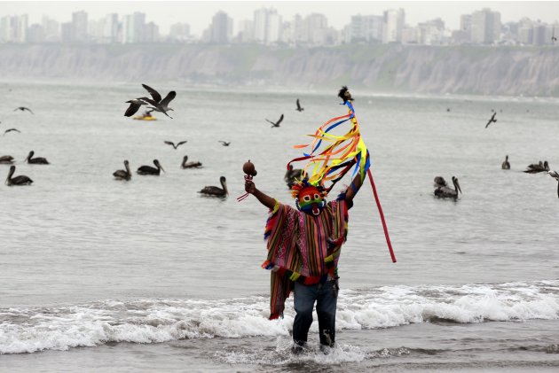 A Peruvian shaman performs a ritual at a beach to prevent the end of the world, in Lima