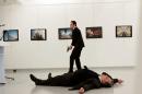 Russian Ambassador to Turkey Andrei Karlov lies on the ground after he was shot by unidentified man at an art gallery in Ankara