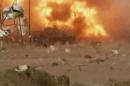 This image made from video shows a car bomb at the moment of impact, one in a series of bombs that exploded Friday, April 25, 2014 at a campaign rally for a Shiite group in Baghdad, Iraq, ahead of the country's parliamentary election. The blasts killed and wounded dozens, officials said. (AP Photo via AP video)