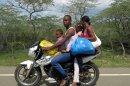 In this July 15, 2013 photo, a family of four travel on a motorcycle on the road between Dajabon and Montecristi, Dominican Republic. The Dominican Republic is effectively the deadliest nation anywhere for drivers, second only to the tiny South Pacific island of Niue, where each death among its roughly 1,400 inhabitants spikes the fatality average. For every 100,000 inhabitants in the Dominican Republic, 42 die every year from traffic accidents, according to the World Health Organization. (AP Photo/Ezequiel Abiu Lopez)