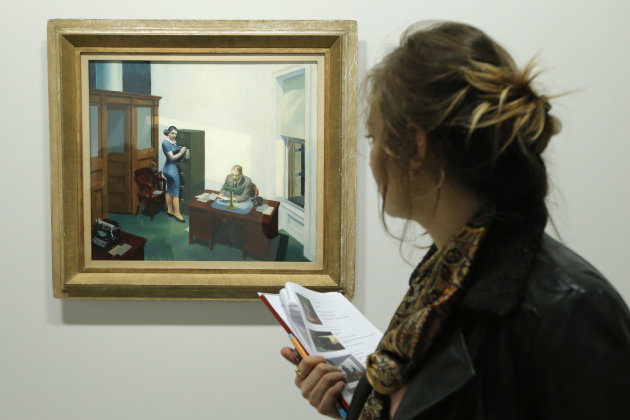 A woman looks at "Office at night, 1940" as part of the retrospective of Edward Hopper works, one of the great American 20th century artists at Paris’ Grand Palais Museum, in Paris, Monday, Oct. 8, 2012. This major Hopper retrospective reveals that the 20th century painter known for his rendering of American life, also drew inspiration from France, and includes some 128 Hopper works, such as the masterpieces “Nighthawks” and “Soir Bleu”.(AP Photo/Francois Mori)