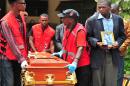The coffin of a victim on the Garissa massacre is rolled out at Chiromo funeral parlour in Nairobi on April 9, 2015