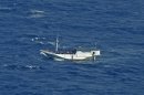 In this photo released by the Indonesian National Search And Rescue Agency, a wooden boat which is believed to have up to 180 asylum seekers on board floats on the waters off Christmas Island, Australia, Wednesday, July 4, 2012. Australian rescuers were trying to help the boat in bad weather and rough seas off Indonesia on Wednesday, a day after the countries agreed to strengthen maritime ties to combat people smuggling. (AP Photo/Indonesian National Search and Rescue Agency)