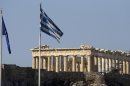 The Greek and European flags fly in front of the Parthenon of the Acropolis prior to a mass anti-government protest, in central Athens on Wednesday, Sept. 26, 2012. More than 50,000 people joined the union-led march during a general strike that ended in violence with clashes between riot police and hundreds of youths. The government in crisis-hit Greece is bracing for a new round of austerity measures despite being stuck in a four-year recession. (AP Photo/Dimitri Messinis)