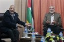 Hamas prime minister Haniyeh gestures during a meeting with Nasir, chairman of the Palestinian Central Election Commission (CEC), in Gaza City