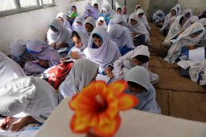 Pakistani female students attend a class at a school …