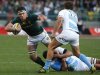 South Africa's Marcell Coetzee breaks past Argentina's Marcelo Bosch and Santiago Fernandez (on ground) during their rugby union test match in Cape Town