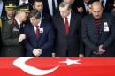 Prime Minister Davutoglu chats with Chief of Staff General Akar as President Erdogan looks on during a funeral ceremony for Army officer Cil in Ankara