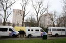 Police vans are parked at the Square Albert I in Brussels during a search after Paris attacks suspect Mohamed Abrini and several other suspects linked to both the Paris and Brussels attacks were arrested, on April 8, 2016