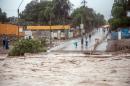 People watch the Copiapo river, overflowing due to heavy rainfall that affected some areas in the city of Copiapo, Chile, on March 25, 2015
