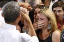 A woman cries while meeting U.S. President Barack Obama at the Coral Reef High School in Miami