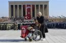 A woman holds the Turkish national flag at the mausoleum of Ataturk in Ankara
