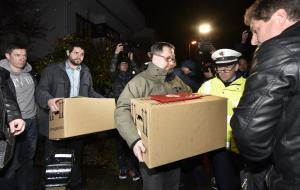 Investigators carry boxes from the apartment of Germanwings …
