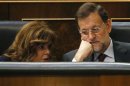 Spain's Prime Minister Rajoy listens to Deputy Prime Minister de Santamaria at the Spanish parliament before his speech on the results of the last European Council in Madrid