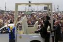 Pope Francis drives past the faithfuls as security reaches out to stop a woman trying to approach the Popemobile during his arrival at Parque Samanes where he will celebrate mass in Guayaquil