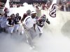 Texas A&M coach Kevin Sumlin, center, leads his team out onto the field before an NCAA college football game against Florida, Saturday, Sept. 8, 2012, in College Station, Texas. Texas A&M begins a new era with its first Southeastern Conference game after leaving the Big 12 Conference. (AP Photo/David J. Phillip)