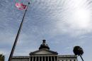 A Confederate flag stands in front of the South Carolina State House in Columbia