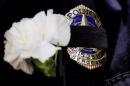File Photo: A Dallas police sergeant wears a mourning band and flower at vigil one day after gunman killed five police officers in Dallas, Texas