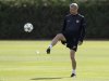 Arsenal manager Arsene Wenger controls the ball during a team training session in London Colney, north of London