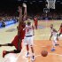 Miami Heat's Bosh reacts after scoring against New York Knicks' Chandler and Smith in their NBA basketball game in New York