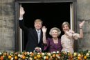 Dutch King Willem-Alexander, Queen Maxima, right, and Princess Beatrix appear on the balcony of the Royal Palace in Amsterdam, The Netherlands, Tuesday April 30, 2013. Around a million people are expected to descend on the Dutch capital for a huge street party to celebrate the first new Dutch monarch in 33 years. (AP Photo/Daniel Ochoa de Olza)
