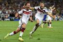 Germany's Goetze celebrates near Mueller after scoring a goal during extra time in their 2014 World Cup final against Argentina at the Maracana stadium in Rio de Janeiro