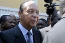 Haiti's former dictator Duvalier moves through the crowd of supporters, journalists and security after he was discharged from a private hospital in Port-au-Prince