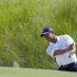 Tiger Woods chips tp the seventh green during the third round of the PGA Championship golf tournament on the Ocean Course of the Kiawah Island Golf Resort in Kiawah Island, S.C., Saturday, Aug. 11, 2012. (AP Photo/Chuck Burton)
