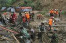 Bangladeshi rescuers search for survivors and bodies following landslides on the outskirts of Chittagong, Bangladesh, Wednesday, June 27, 2012. Rescuers said the slides caused by heavy monsoon rains have killed at least 30 people in southern Bangladesh. (AP Photo/Anrup Titu)