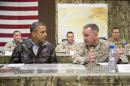 FILE - This May 25, 2014, file photo shows President Barack Obama as he is briefed by Marine General Joseph Dunford, commander of the US-led International Security Assistance Force (ISAF), right, after arriving at Bagram Air Field for an unannounced visit north of Kabul, Afghanistan. The Afghan election crisis and unraveling of Iraq has lawmakers and others thinking President Barack Obama should re-think his decision to withdrawal virtually all U.S. troops from Afghanistan by the close of 2016. (AP Photo/ Evan Vucci, File)