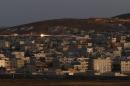Tracer rounds light the sky over the Syrian town of Kobani during heavy fighting downtown, as seen from the Mursitpinar crossing on the Turkish-Syrian border in the southeastern town of Suruc in Sanliurfa province