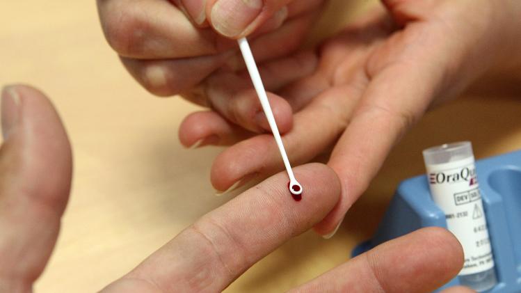 A nurse tests for hepatitis C at a hospital in France