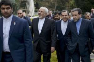 Iranian Foreign Minister Javad Zarif walks with others &hellip;
