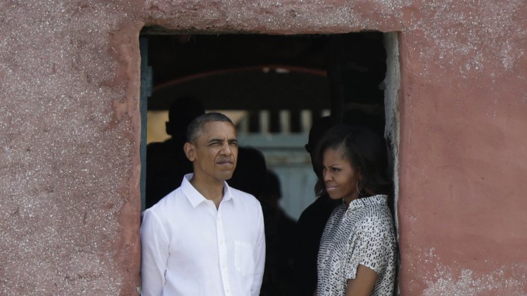 U.S. President Barack Obama and first lady Michelle Obama look out of a doorway that slaves departed from on Goree Island in Dakar