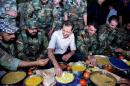 Syria's President Bashar al-Assad joins Syrian army soldiers for Iftar in the farms of Marj al-Sultan village